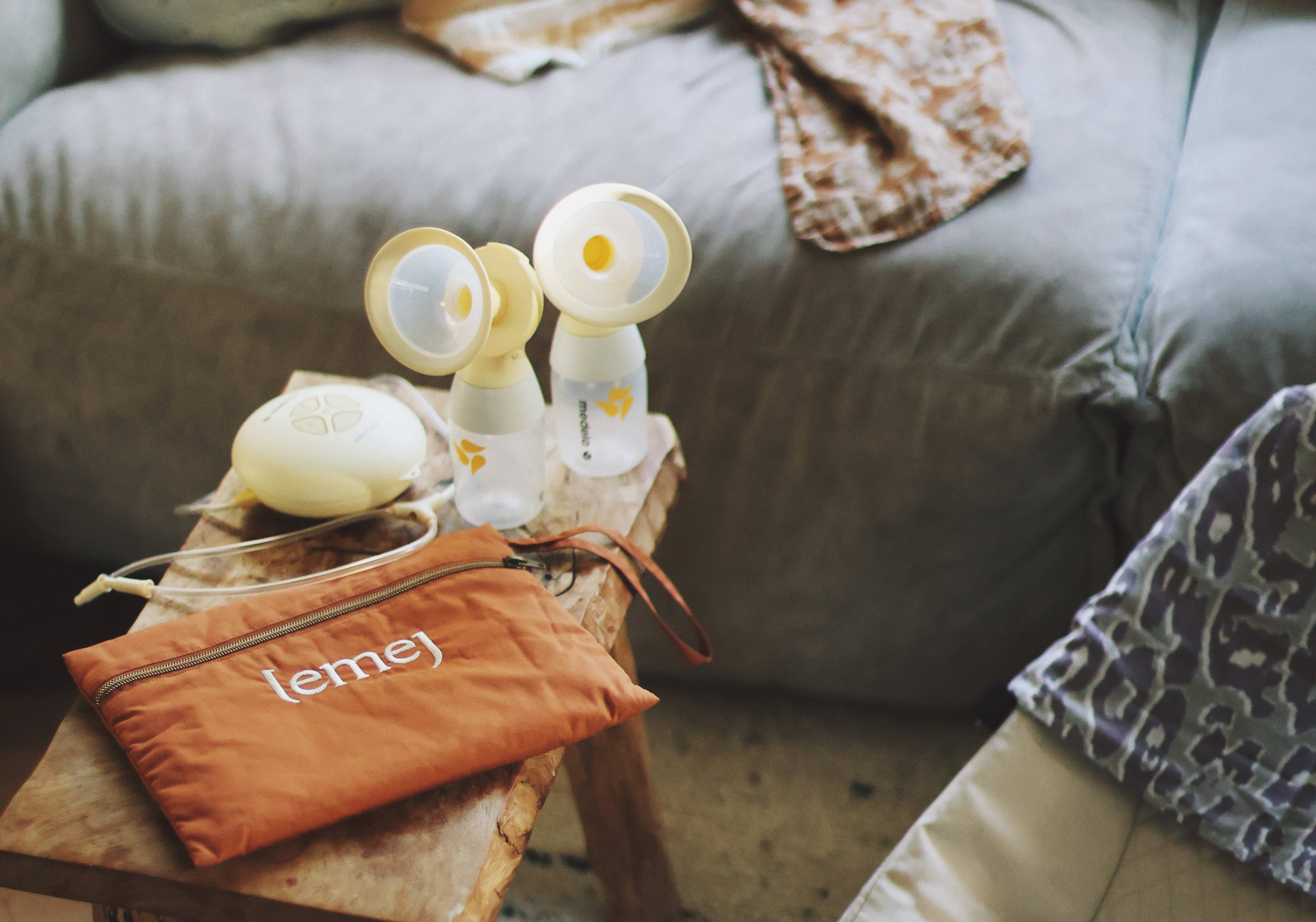 Orange bag with 'lemey' branding on a small wooden table in a living room setting.